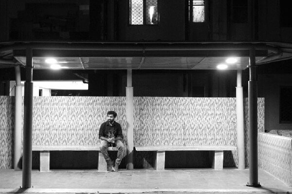 Subject sitting at a bus stop, waiting