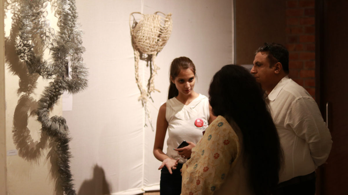Student showcasing her work at the first IIAD graduate show 2019