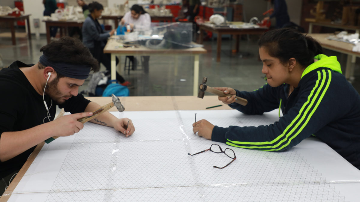Students working with various tools in the Material Construction Lab