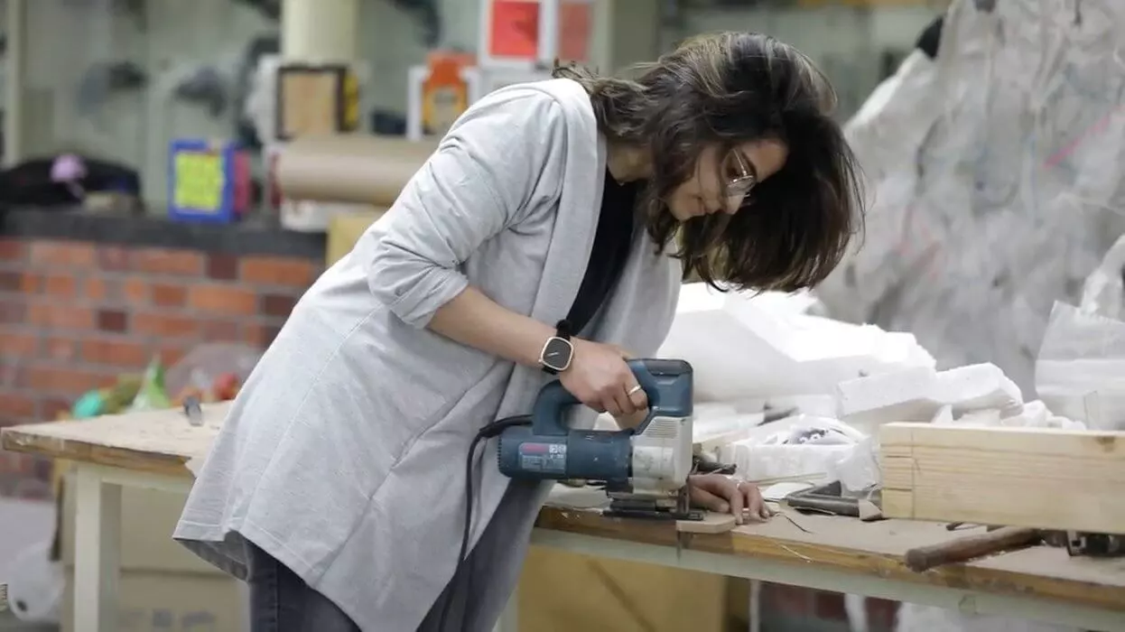 A student working with a drill machine in the material lab