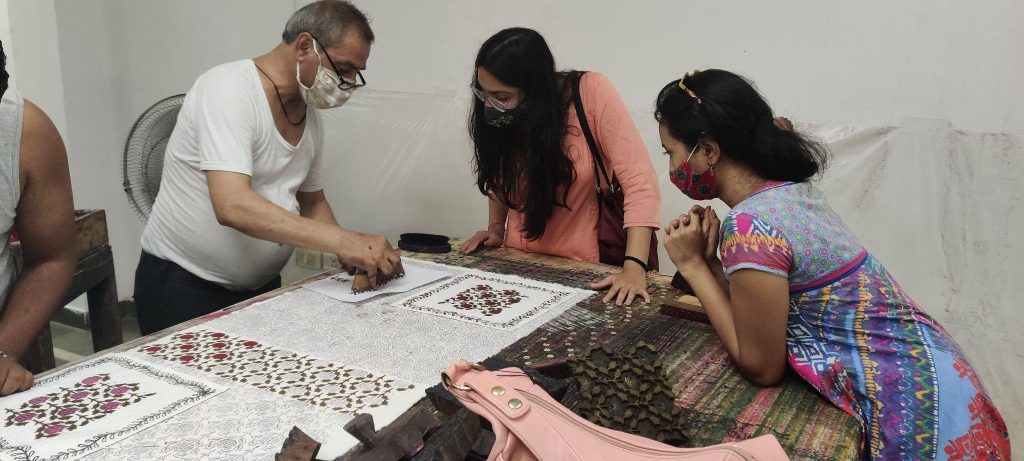 Master Ji showing the students and faculty the technique of block printing