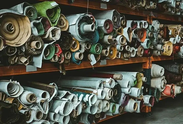 Rolls of colorful fabric stacked