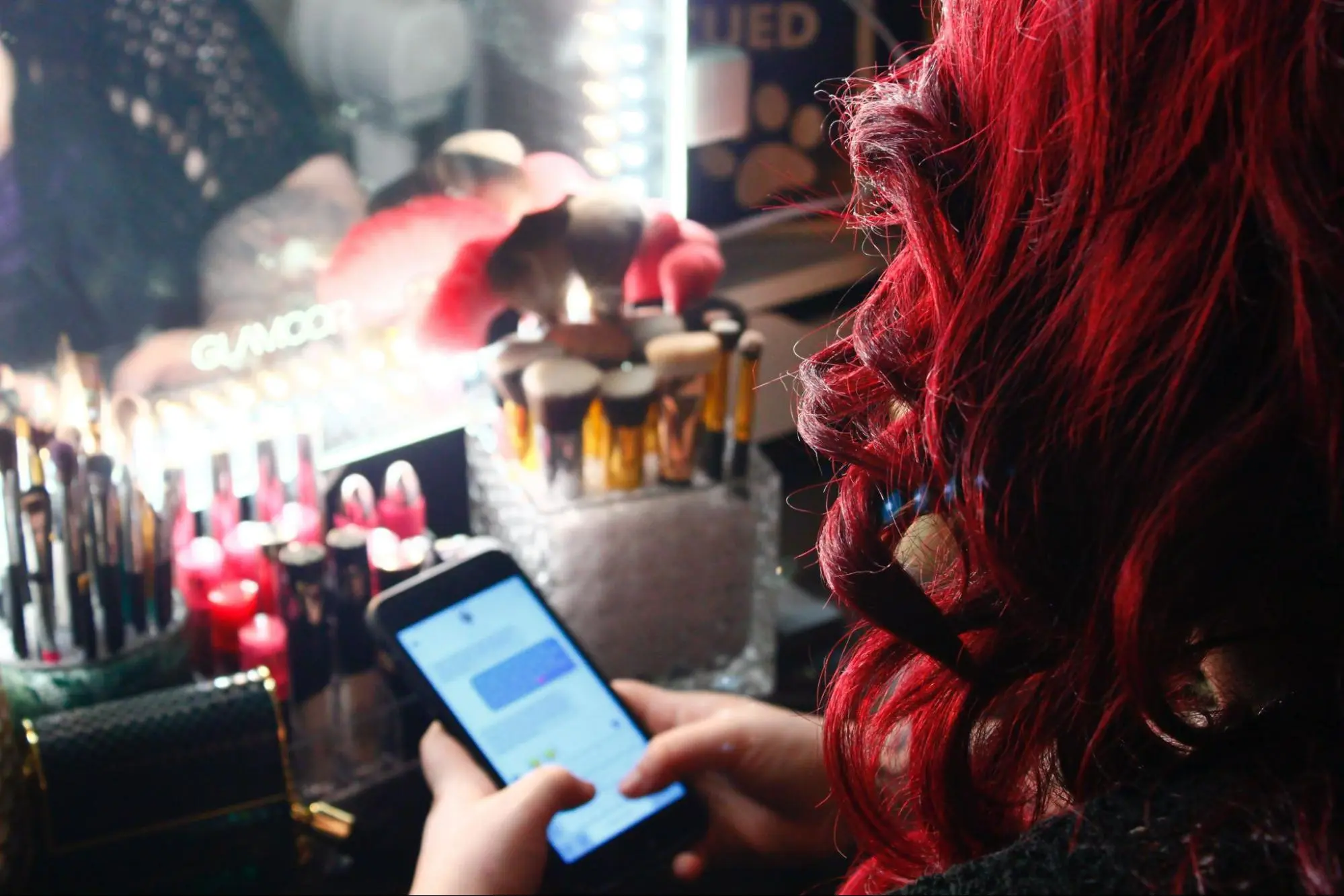 Person using smartphone with makeup