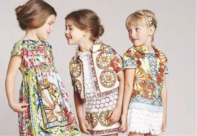 3 kids showcasing different styles of clothing
