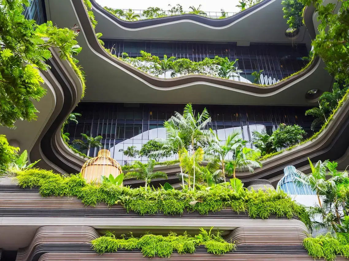 Sustainable building with green terraces and plants