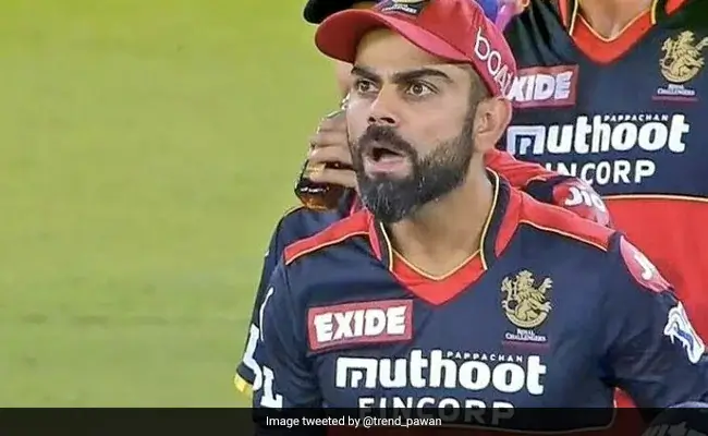 Virat Kohli in Royal Challengers Bangalore jersey showing intense expression during an IPL cricket match.
